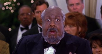 Movie still from “The Nutty Professor” (1996), directed by Tom Shadyac – A man in a tuxedo with a surprised look on his face; Close Up shot, Low angle