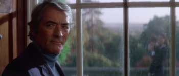 Movie still from “The Omen” (1976), directed by Richard Donner – An older man standing in front of a window; Close Up shot, Over the shoulder angle