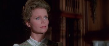 Movie still from “The Omen” (1976), directed by Richard Donner – A person wearing a suit and tie; Close Up shot, Low angle