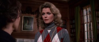 Movie still from “The Omen” (1976), directed by Richard Donner – A person wearing a sweater; Close Up shot, Over the shoulder angle