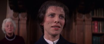 Movie still from “The Omen” (1976), directed by Richard Donner – A person wearing a suit; Close Up shot, Low angle