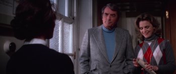 Movie still from “The Omen” (1976), directed by Richard Donner – A man wearing a suit and a blue shirt; Medium shot, Over the shoulder angle