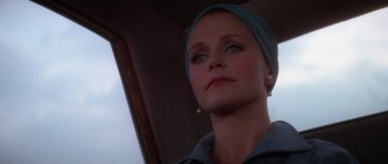 Movie still from “The Omen” (1976), directed by Richard Donner – A person wearing a headscarf; Close Up shot, Low angle