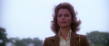 Movie still from “The Omen” (1976), directed by Richard Donner – A person wearing a suit and tie; Close Up shot, Low angle