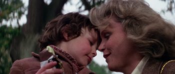 Movie still from “The Omen” (1976), directed by Richard Donner – A person and a child face to face; Close Up shot, Low angle