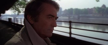 Movie still from “The Omen” (1976), directed by Richard Donner – A person looking out of a window; Close Up shot, Low angle