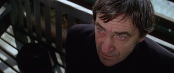 Movie still from “The Omen” (1976), directed by Richard Donner – A person looking at the camera; Close Up shot, High angle