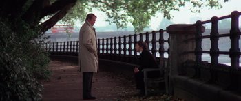 Movie still from “The Omen” (1976), directed by Richard Donner – Two men sitting on a bench in a park; Wide shot, Over the shoulder angle