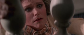 Movie still from “The Omen” (1976), directed by Richard Donner – A person wearing a bow tie; Close Up shot, Overhead angle