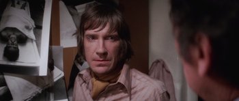 Movie still from “The Omen” (1976), directed by Richard Donner – A person wearing a shirt and tie; Close Up shot, Low angle