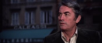 Movie still from “The Omen” (1976), directed by Richard Donner – A person wearing a suit; Close Up shot, Over the shoulder angle