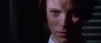 Movie still from “The Omen” (1976), directed by Richard Donner – A woman's face in the dark; Close Up shot, Over the shoulder angle