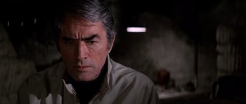 Movie still from “The Omen” (1976), directed by Richard Donner – A person wearing a shirt; Close Up shot, Over the shoulder angle