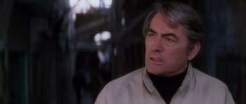 Movie still from “The Omen” (1976), directed by Richard Donner – A person wearing a jacket; Close Up shot, Over the shoulder angle