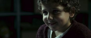 Movie still from “The Orphanage” (2007), directed by J.A. Bayona – A child's face in a dark room; Close Up shot, Over the shoulder angle
