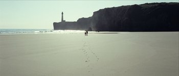 Movie still from “The Orphanage” (2007), directed by J.A. Bayona – Two people walking on the beach near the ocean; Extreme Wide shot, High angle