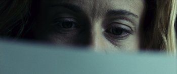 Movie still from “The Orphanage” (2007), directed by J.A. Bayona – A woman's eyes with a sheet of paper behind them; Extreme Close Up shot, Over the shoulder angle