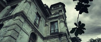 Movie still from “The Orphanage” (2007), directed by J.A. Bayona – An old building with a lot of windows on the outside; Extreme Wide shot, Low angle