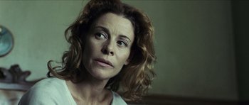 Movie still from “The Orphanage” (2007), directed by J.A. Bayona – A person with curly brown hair; Close Up shot, Low angle