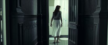 Movie still from “The Orphanage” (2007), directed by J.A. Bayona – A woman standing in front of a window; Wide shot, Over the shoulder angle