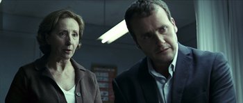 Movie still from “The Orphanage” (2007), directed by J.A. Bayona – A man and a woman standing next to each other in a room; Close Up shot, Over the shoulder angle