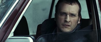 Movie still from “The Orphanage” (2007), directed by J.A. Bayona – A person sitting in a car; Close Up shot, Over the shoulder angle