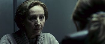 Movie still from “The Orphanage” (2007), directed by J.A. Bayona – An older woman sitting in front of a mirror; Close Up shot, Over the shoulder angle