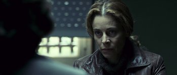Movie still from “The Orphanage” (2007), directed by J.A. Bayona – A woman in a leather jacket stares into the distance; Close Up shot, Over the shoulder angle