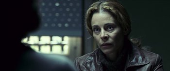 Movie still from “The Orphanage” (2007), directed by J.A. Bayona – A woman in a leather jacket looking at the camera; Close Up shot, Over the shoulder angle