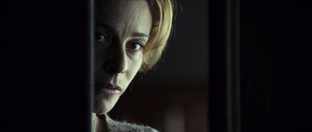 Movie still from “The Orphanage” (2007), directed by J.A. Bayona – A person's face in a dark room; Close Up shot, Low angle