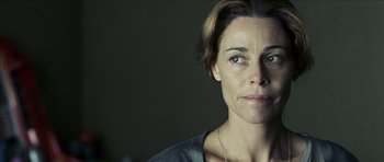 Movie still from “The Orphanage” (2007), directed by J.A. Bayona – A person wearing a necklace; Close Up shot, Over the shoulder angle