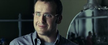 Movie still from “The Orphanage” (2007), directed by J.A. Bayona – A person wearing glasses; Close Up shot, Over the shoulder angle