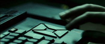 Movie still from “The Orphanage” (2007), directed by J.A. Bayona – A person's fingers on a laptop keyboard; Extreme Close Up shot, Overhead angle