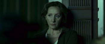 Movie still from “The Orphanage” (2007), directed by J.A. Bayona – An older woman is looking at the camera; Close Up shot, Over the shoulder angle