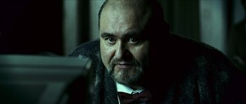 Movie still from “The Orphanage” (2007), directed by J.A. Bayona – A person with a beard wearing a tie; Close Up shot, Over the shoulder angle