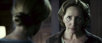 Movie still from “The Orphanage” (2007), directed by J.A. Bayona – An older woman looking at a younger man in front of a mirror; Close Up shot, Over the shoulder angle
