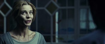 Movie still from “The Orphanage” (2007), directed by J.A. Bayona – A woman standing in front of a window; Close Up shot, Over the shoulder angle