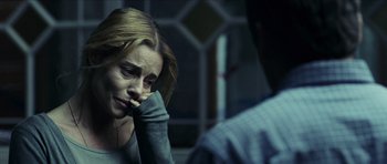 Movie still from “The Orphanage” (2007), directed by J.A. Bayona – A woman sitting in front of a man in front of a window; Close Up shot, Over the shoulder angle