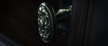 Movie still from “The Orphanage” (2007), directed by J.A. Bayona – View of a door knob on a wooden door; Extreme Close Up shot, High angle