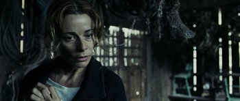 Movie still from “The Orphanage” (2007), directed by J.A. Bayona – A woman in black jacket looking at the camera; Close Up shot, Low angle