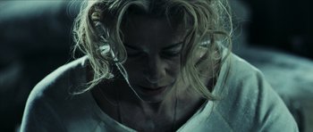 Movie still from “The Orphanage” (2007), directed by J.A. Bayona – A person with long blonde hair; Close Up shot, Overhead angle