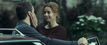 Movie still from “The Orphanage” (2007), directed by J.A. Bayona – A man and a woman holding their hands together; Close Up shot, Over the shoulder angle
