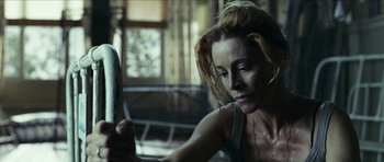 Movie still from “The Orphanage” (2007), directed by J.A. Bayona – A woman is looking at her reflection in a mirror; Close Up shot, Low angle