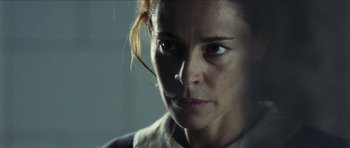 Movie still from “The Orphanage” (2007), directed by J.A. Bayona – A woman's face in a dark room; Close Up shot, Low angle