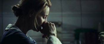 Movie still from “The Orphanage” (2007), directed by J.A. Bayona – A woman holding her hand to her mouth; Close Up shot, Low angle