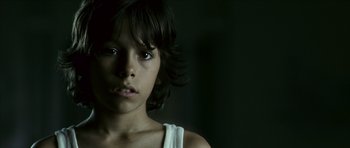 Movie still from “The Orphanage” (2007), directed by J.A. Bayona – A person with a white shirt; Close Up shot, Low angle