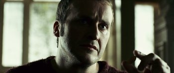 Movie still from “The Orphanage” (2007), directed by J.A. Bayona – A man's face in a dark room; Close Up shot, Low angle