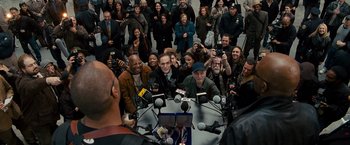Movie still from “The Other Guys” (2010), directed by Adam McKay – A group of people sitting around a table with microphones; Wide shot, Overhead angle