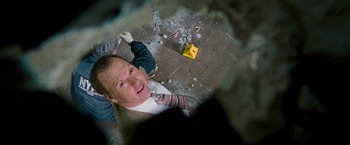 Movie still from “The Other Guys” (2010), directed by Adam McKay – A man in a suit and tie is looking up at the camera; Close Up shot, Overhead angle