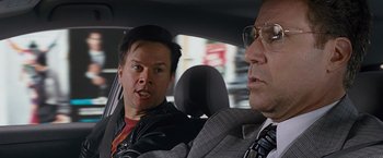 Movie still from “The Other Guys” (2010), directed by Adam McKay – A man and a woman sitting in the back seat of a car; Close Up shot, Over the shoulder angle